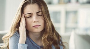 Woman suffering from a TMD-related headache