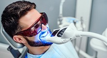 Man undergoing teeth-whitening procedure in the office