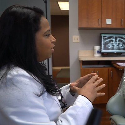 Dentist talking to dental patient