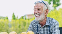 Man smiles outdoors