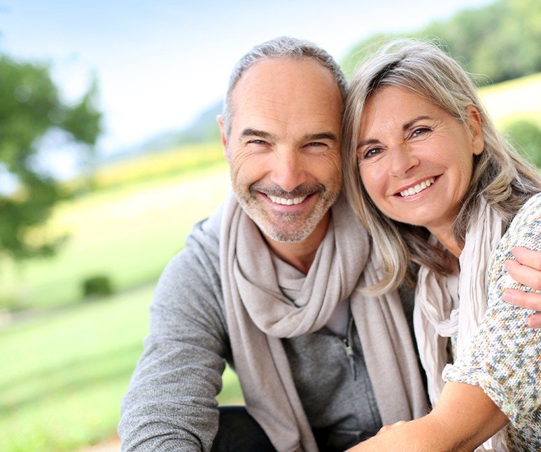 Older couple smiling outdoors