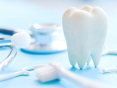 tooth, stethoscope, and toothbrush on a table