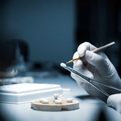 A dentist working on a dental crown