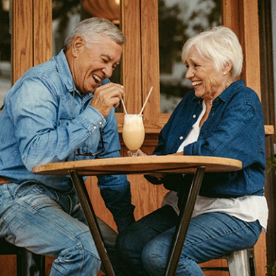 Senior couple with dentures in McKinney sharing a milkshake