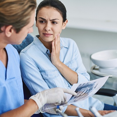 Patient listening to her emergency dentist in McKinney