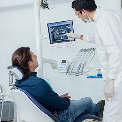 McKinney emergency dentist showing X-ray to a patient