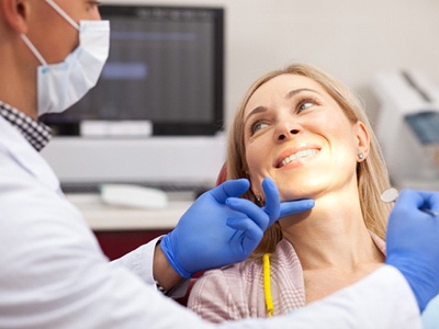 Woman sitting in dental chair at dentist.