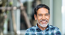 man smiling with dental implants in McKinney