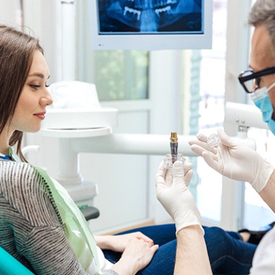 dentist in McKinney explaining dental implants to patient