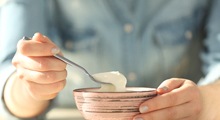 patient eating yogurt after getting dental implants in McKinney