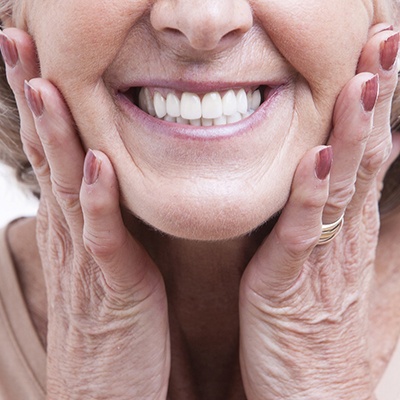 Closeup of older woman’s smile with dental implants in McKinney