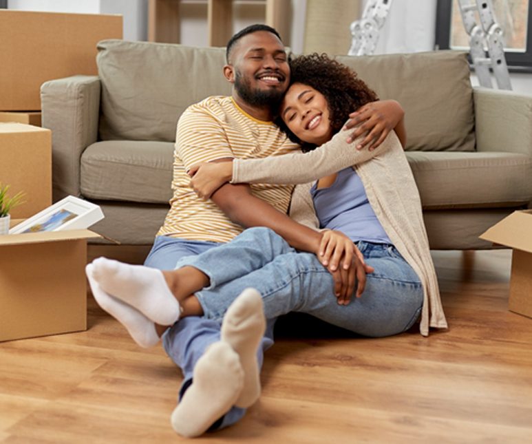 couple unpacking their apartment and hugging each other