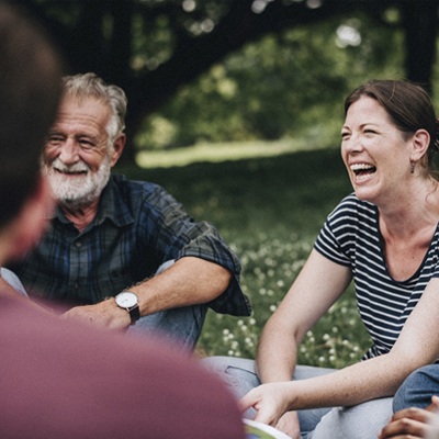 person smiling and speaking with their friends