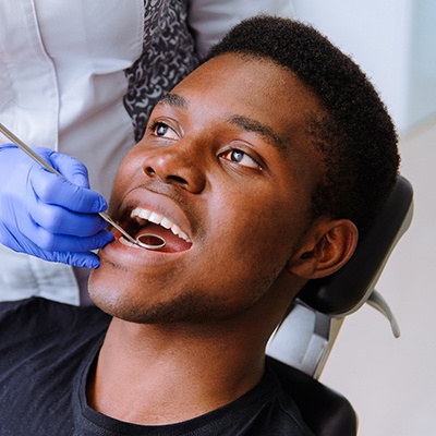 Man completing dental checkup to prevent dental emergencies in McKinney 