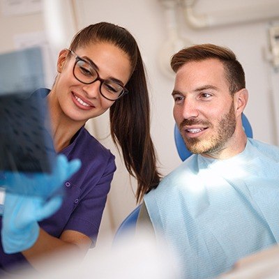 Dentist and patient looking at x-rays