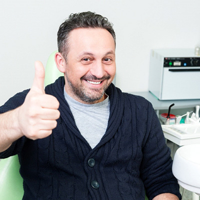 Man giving a thumbs up while wearing a black shirt