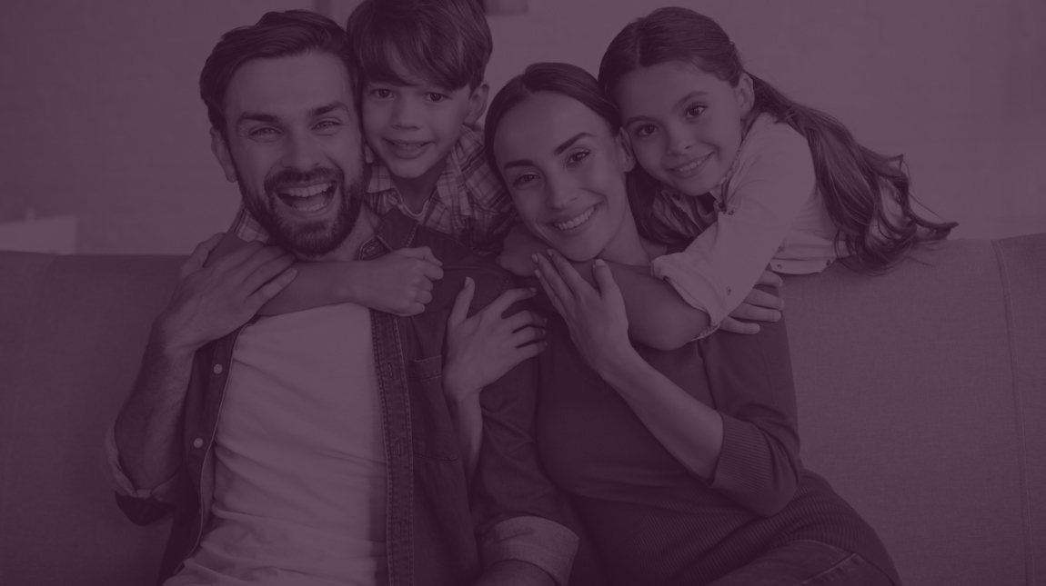 Family of four laughing together