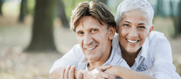 Smiling older man and woman outdoors