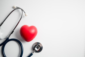 Stethoscope lying next to a foam heart