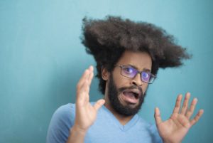 Frightened man in front of blue background