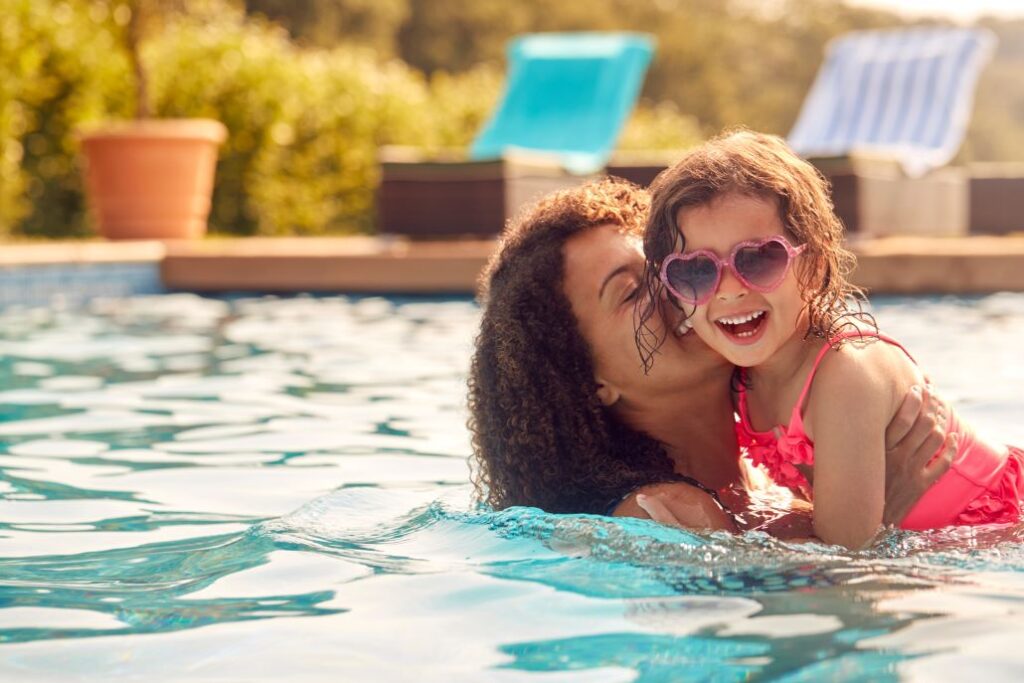 A woman and child in pool.