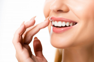 Close up of woman smiling and touching her lips