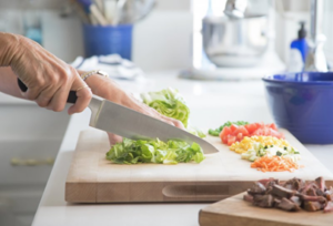 Close up of woman chopping vegetables